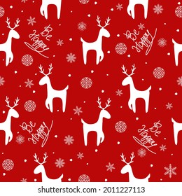 Vector Christmas pattern.Seamless background with snowflakes,deer on a red background.It is used for wrapping paper,in the production of fabrics,wrappers, wallpaper.