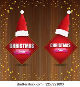 vector Christmas sales banner or tag label with red santa hat on wooden background with stars. Red winter Christmas sale poster design template or background - Vector