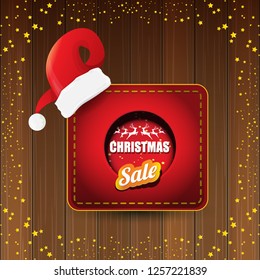 vector Christmas sales banner or tag label with red santa hat on wooden background with stars. Red winter Christmas sale poster design template or background - Vector