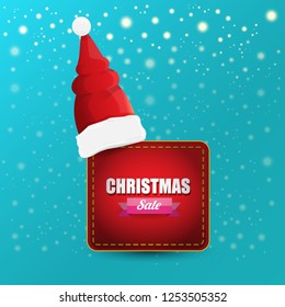 vector Christmas sales paper banner or tag label with red santa hat on snowy azure background with falling snowflakes. Red winter Christmas sale poster design template or background