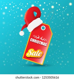 vector Christmas sales paper banner or tag label with red santa hat on snowy azure background with falling snowflakes. Red winter Christmas sale poster design template or background