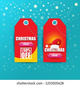 vector Christmas sales paper banner or tag label with red santa hat on snowy azure background with falling snowflakes. Red winter Christmas sale poster design template or background