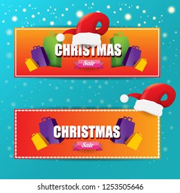 vector Christmas sales paper banner or tag label with red santa hat on snowy azure background with falling snowflakes. Red winter Christmas sale poster design template or background