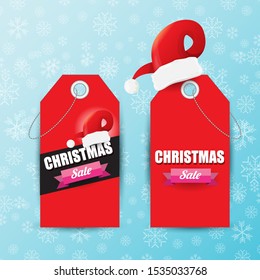 vector Christmas sales paper banner or tag label with red santa hat on snowy blue background with falling snowflakes. Red winter Christmas sale poster design template or background