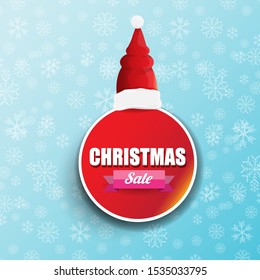 vector Christmas sales paper banner or tag label with red santa hat on snowy blue background with falling snowflakes. Red winter Christmas sale poster design template or background