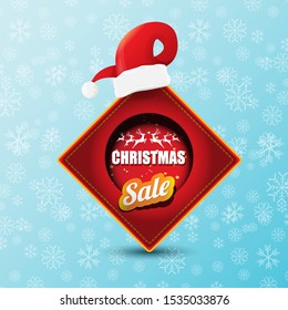 vector Christmas sales paper banner or tag label with red santa hat on snowy blue background with falling snowflakes. Red winter Christmas sale poster design template or background