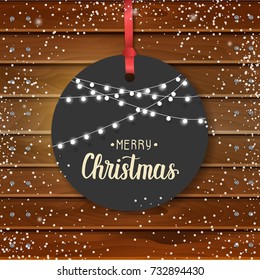 Vector Christmas vintage label with hand made quote "Merry Christmas" and garlands on wooden board. Happy New Year. Sketch. Greeting background. Lettering, sketch. Banner, flyer, poster, brochure.