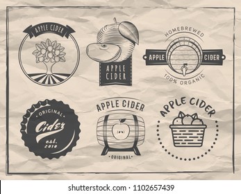 Vector cider logos and badges. Set of retro labels for apple cider drink. Vintage paper background.