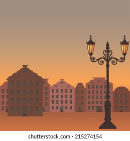 vector city evening in orange colors with square and light of the street lamps
