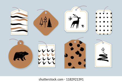 Vector collection of christmas cards, gift tags and badges isolated on light background. Emblems for xmas holiday presents packaging in hand drawn sketch style. Bear, fir tree, deer, artistic patterns