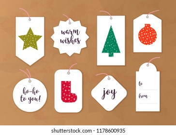 Vector collection of christmas gift tags and badges different shapes isolated on paper background. Emblems for xmas holiday presents packaging. New year pattern, text place, congratulations.