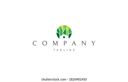 Vector color logo on which an abstract image of the silhouette of a house on a forest background.