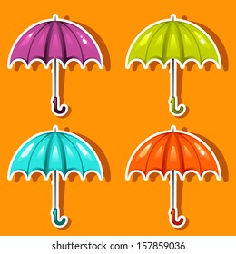 vector colored umbrella icons in front of the orange background