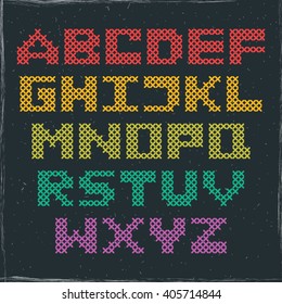 Vector colorful alphabet, capital letters embroidered with a cross on blackboard background. Cross stitched ABC. Design for crafters, scrapbooking or children primer book.