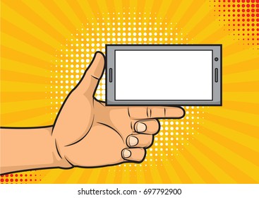 Vector colorful hand drawn illustration in retro comic style. Pop art dot background with male hand with thumb up holding a smartphone with empty screen for your offer.