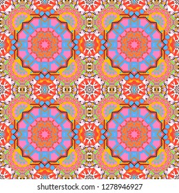 Vector colorful kaleidoscopic seamless pattern for textile, ceramic tiles, wallpapers and fabric. Traditional ethnic background in pink, orange and blue colors.