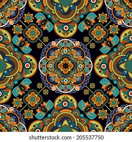 Vector colorful seamless pattern in ethnic style. Geometric batik. Indian backdrop with stylized flowers. Design for cover, wrapping paper, fabric, textile
