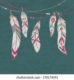 Vector colorful set of ethnic decorative feathers hanging on threads