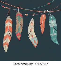 Vector colorful set of ethnic decorative feathers hanging on threads