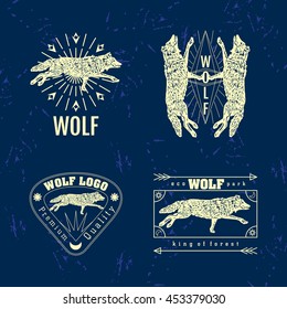 Vector colorful set with forest wolf. The wolf as main element of logotypes on dark blue background.