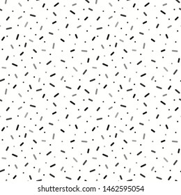 Vector confetti and sprinkles seamless background design in black and white tones 
