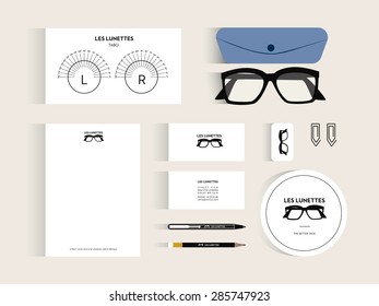 Vector Corporate Identity Mock Up For An Optician Shop, With Glasses, Letter Head And Logo On Beige Background. Vector And Illustration Design.