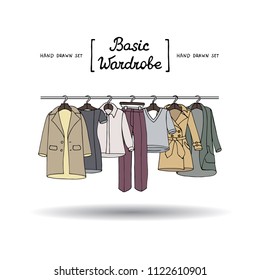 Vector cover with hand drawn colored basic wardrobe on white background. Illustration on the theme of fashion
