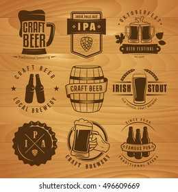 Vector craft beer labels and logos. Set of retro beer badges on the wooden background