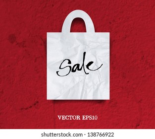 Vector crumpled paper shopping bag icon over grungy background with original handwritten calligraphy "Sale"