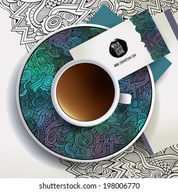 Vector Cup of coffee, business cards and hand drawn floral ornament on a saucer and background