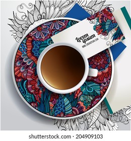 Vector Cup of coffee, business cards and hand drawn floral ornament on a saucer and background