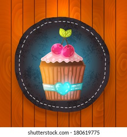 vector cupcake with cream and cherry. Muffin badge on wood background