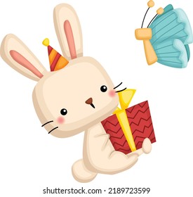 a vector of a cute rabbit holding a birthday present