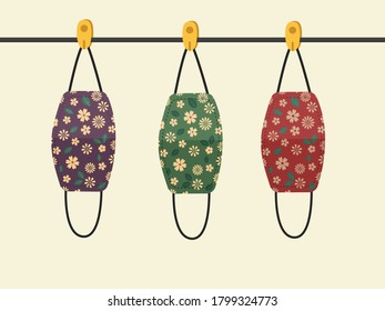 Vector design. The colorful flowers pattern cloth face mask is hanging for sunlight get dried after used and washed. Reuse after cleanness for protect virus. 