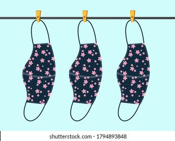 Vector design. The flowers pattern cloth face mask is hanging for sunlight get dried after used and washed. Reuse after cleanness for protect virus. 