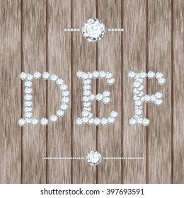vector diamond  jewelry letters d e f with gemstones on wooden background 