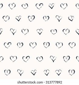Vector doodle seamless pattern. Black and white illustration. Grungy hearts in rows. Romantic background design. Naive style.