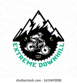 Vector downhill mountain biking badge, logo, label with rider on a bike and mountain silhouette. Downhill, enduro, cross-country biking illustration