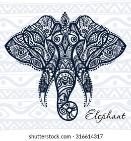 Vector drawing of a elephant with ethnic patterns of India. On the background of pattern. Image as a tattoo.