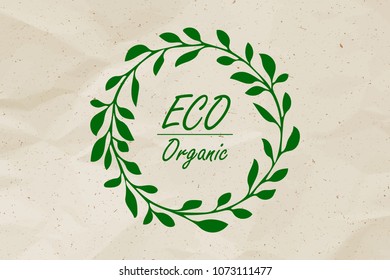 Vector eco card for eco friendly product. Eco Organic words in floral wreath on crumpled kraft paper background.