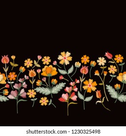 Vector embroidery border with cute wild flowers. Seamless floral embroidered pattern on black background. Fahion design for clothing.