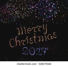 VECTOR eps 10. Glowing collection. 2017 New Year design! Shining Fireworks, light effects isolated and grouped. Shining violet lettering text "Merry CHRISTMAS". Golden fireworks. Brushes included!
