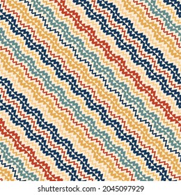 Vector ethnic pattern. Tribal traditional ornament with colored diagonal zigzags and lines. The seamless background is used for the design of carpets, clothing, textiles, wallpapers, business cards.