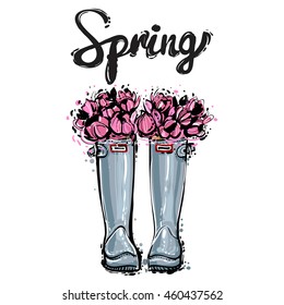 Vector fashion sketch. Hand drawn illustration of blue rubber boots with pink flowers bouquet and Spring lettering. Trendy glamour greeting card design in vogue style. Isolated elements on white