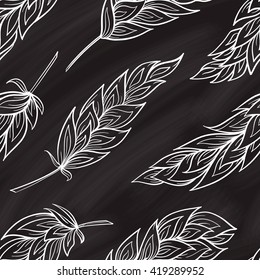 Vector feathers seamless pattern on a chalkboard background. Boho style.