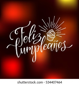 Vector Feliz Cumpleanos, translated Happy Birthday lettering design. Festive illustration on blurred background for greeting or invitation cards templates. 