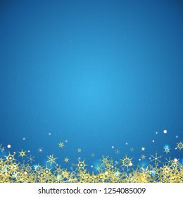 vector file with beautiful falling snow flakes colored golden and lightning effects on blue colored background