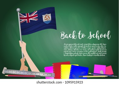 Vector flag of Anguilla on Black chalkboard background. Education Background with Hands Holding Up of Anguilla flag. Back to school with pencils, books, school items learning and childhood concept.