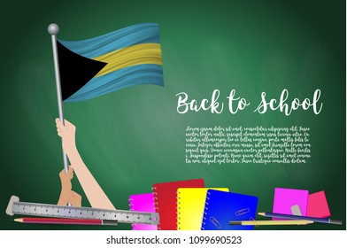 Vector flag of bahamas on Black chalkboard background. Education Background with Hands Holding Up of bahamas flag. Back to school with pencils, books, school items learning and childhood concept.