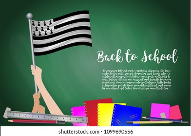 Vector flag of brittany on Black chalkboard background. Education Background with Hands Holding Up of brittany flag. Back to school with pencils, books, school items learning and childhood concept.